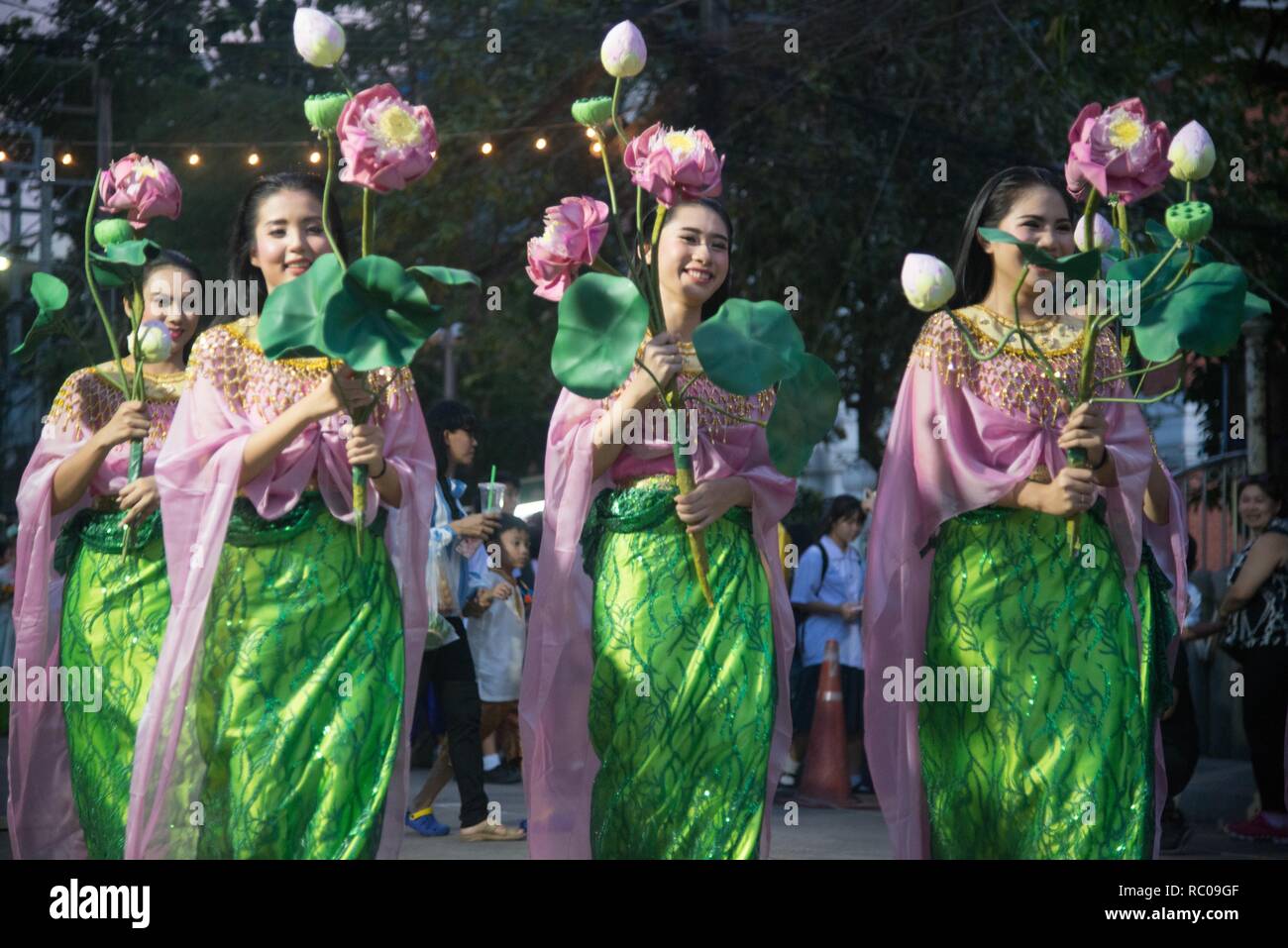 The parade of Thai pretty woman holding lotus flower show on street of Loykratong festival Stock Photo