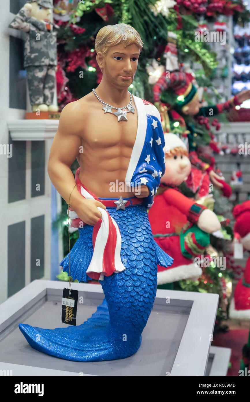Kitschy Merman Statue for sale in a Christmas Shop in Little Italy, New York City, USA Stock Photo