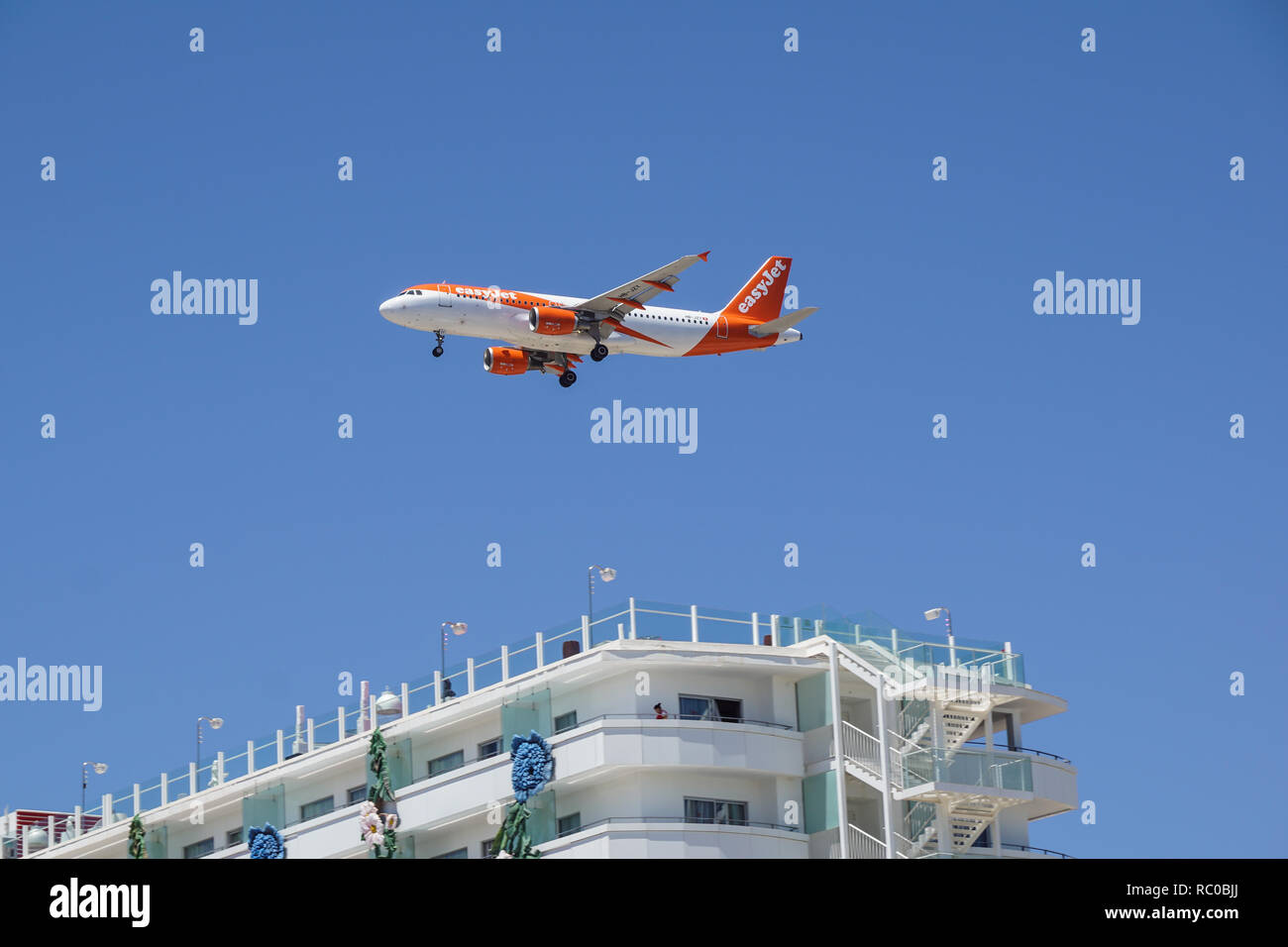Ibiza Spain June 16-06-2018 - Airplane easyJet Airbus A319-100 is flying to the runway. The Commercial jet aeroplane started the landing gear system for landing. Stock Photo