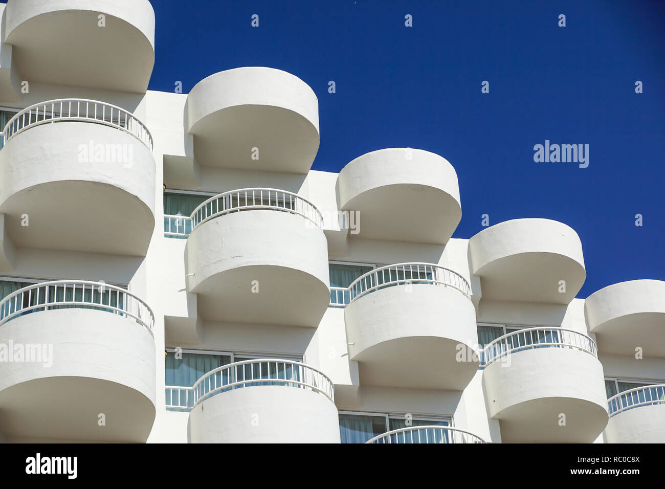 Balconies of a modern building . blue sky background Stock Photo - Alamy