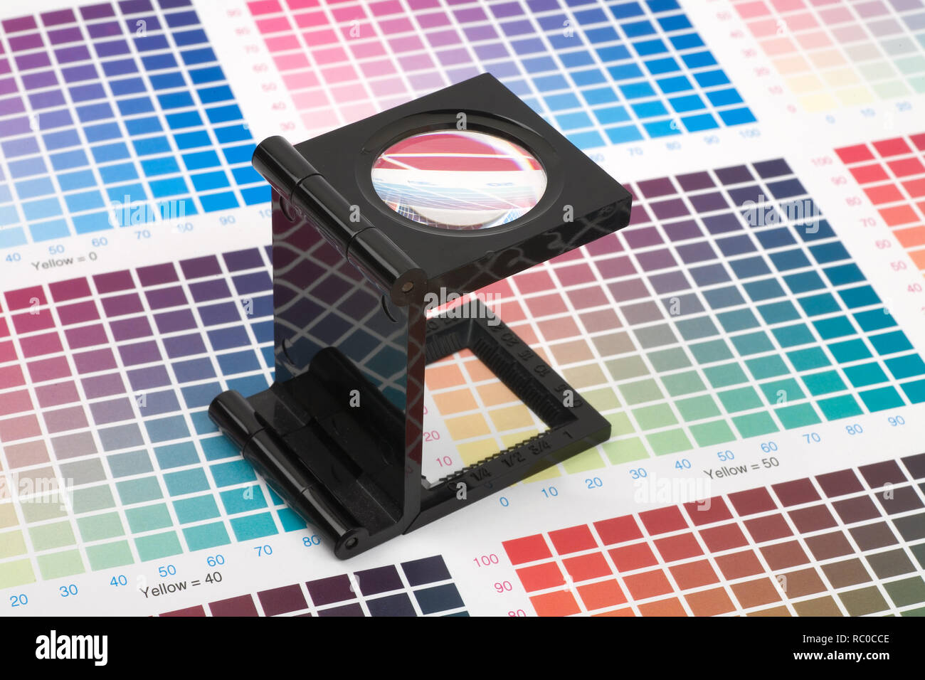 Printing loupe standing on colour swatch paper Stock Photo Alamy