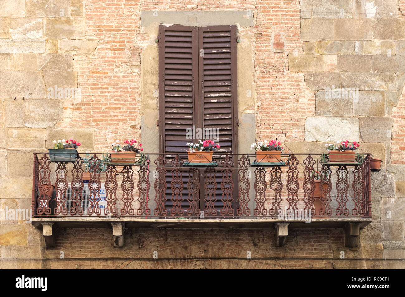 Decorative balcony with wooden shutters on house front. Pisa. Tuscany; Italy; Europe; Stock Photo