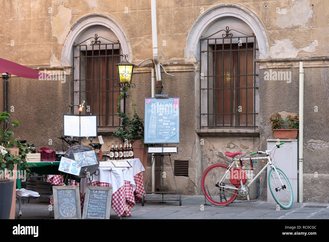 empty restaurant displaying menus and bicycle, Pisa, Tuscany, Italy, Europe, Stock Photo