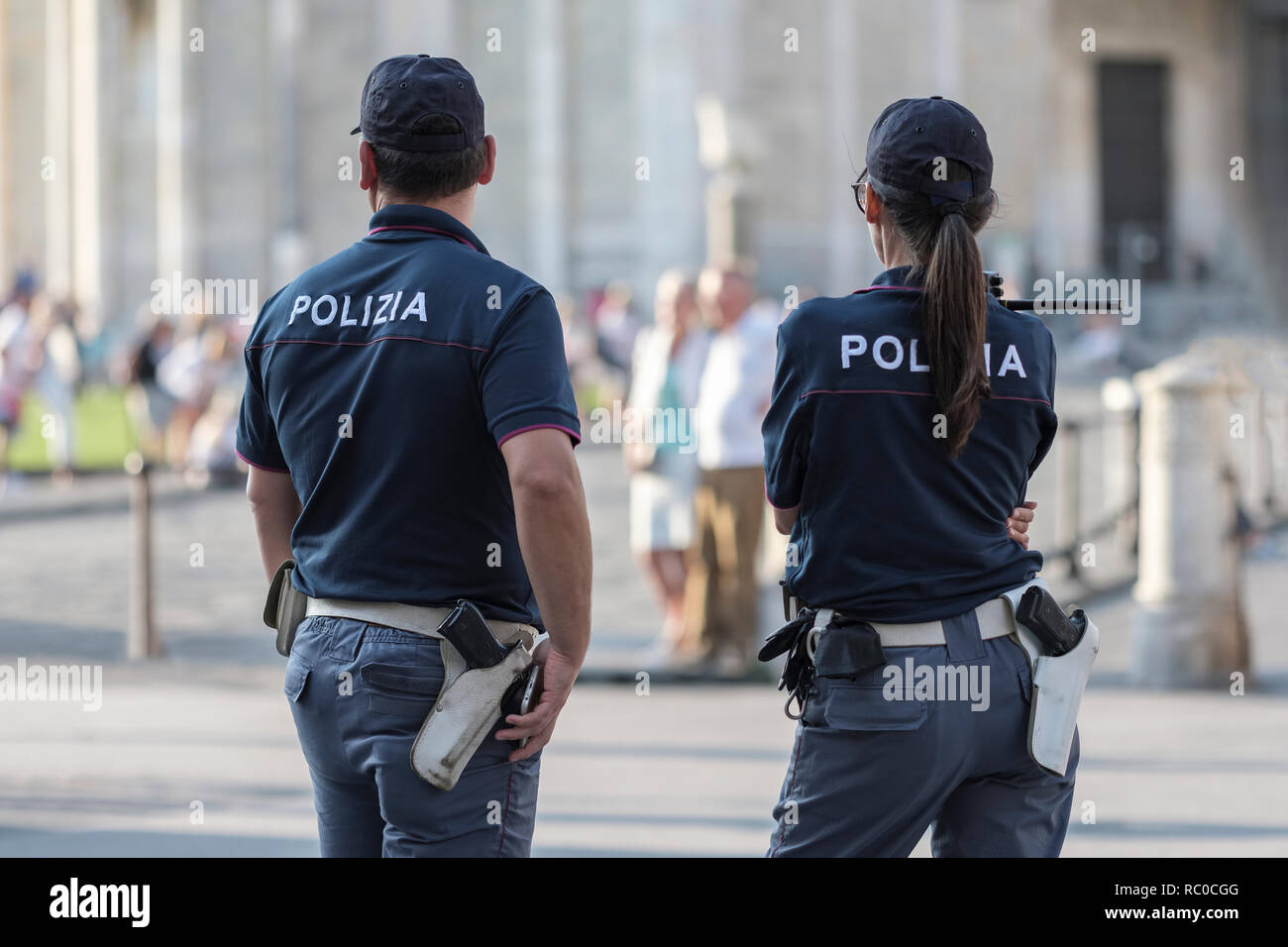 Male and female police officers on duty, Pisa, Tuscany, Italy, Europe Stock Photo