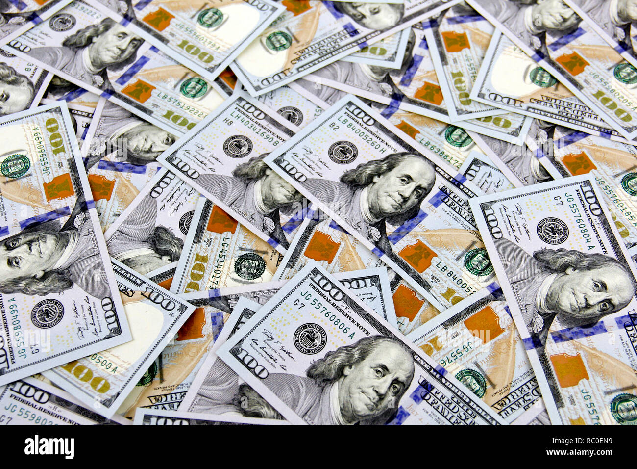 Several Hundred dollar bills make a cash background Stock Photo