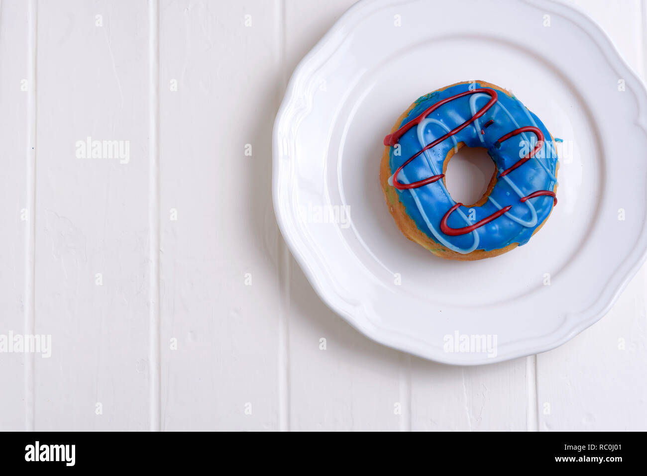 Colorful Donuts with Coffee in White Backdrop Stock Photo