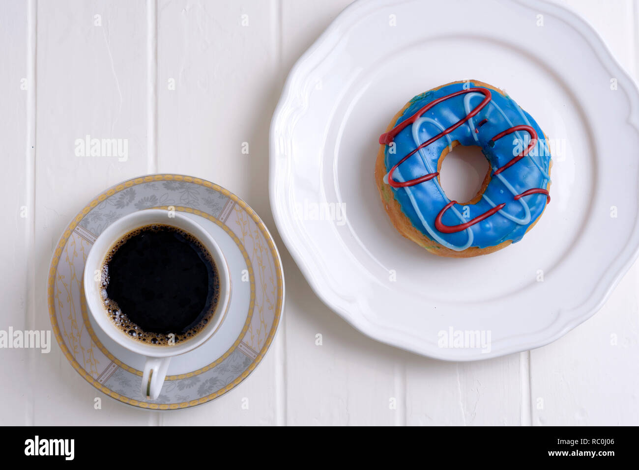 Colorful Donuts with Coffee in White Backdrop Stock Photo