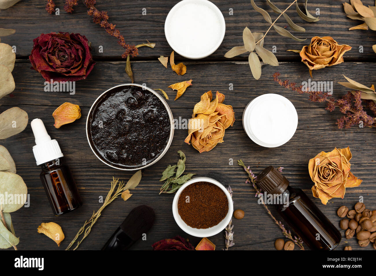 Aromatic botanical cosmetics. Dried herbs flowers mixture, aromatic homemade scrub paste made from coffee grounds and oils. Holistic herbal DIY skinca Stock Photo