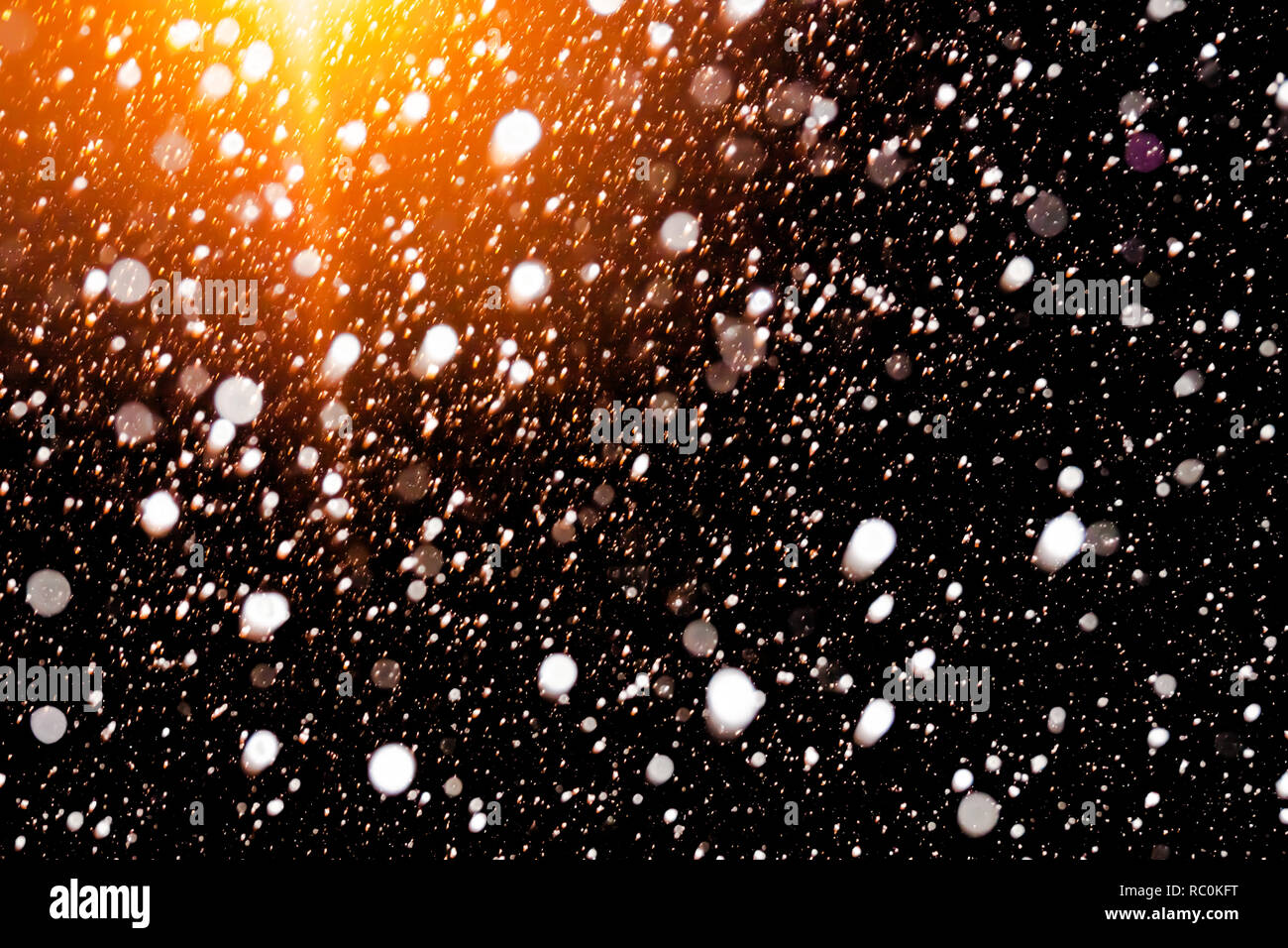 abstract background of falling snow. white snowflakes on a black ...