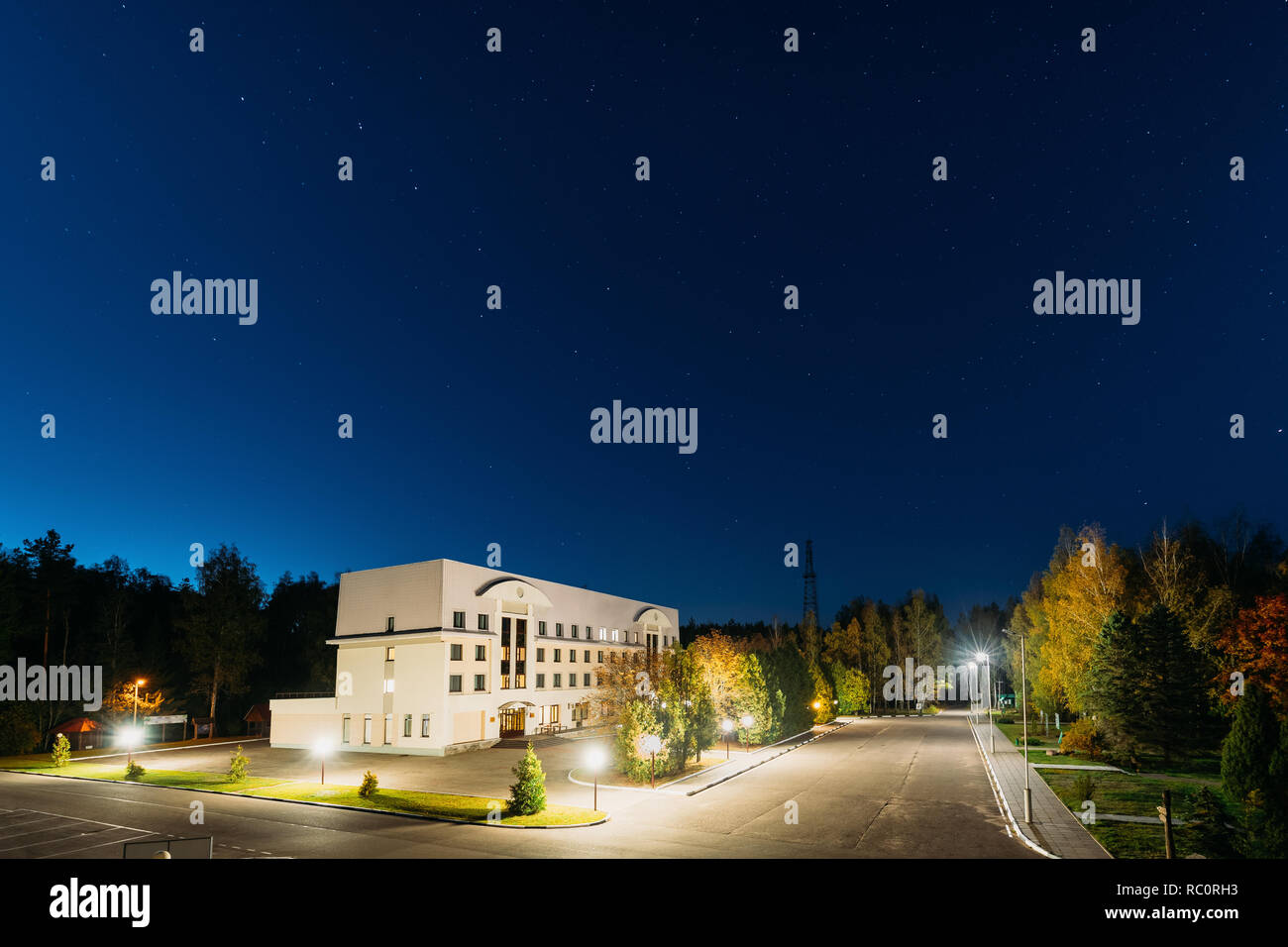 Domzheritsy, Vitebsk Region, Belarus. Hotel Complex Serguch In Berezinsky Biosphere Reserve In Evening Night Illuminations Under Starry Sky. Stock Photo