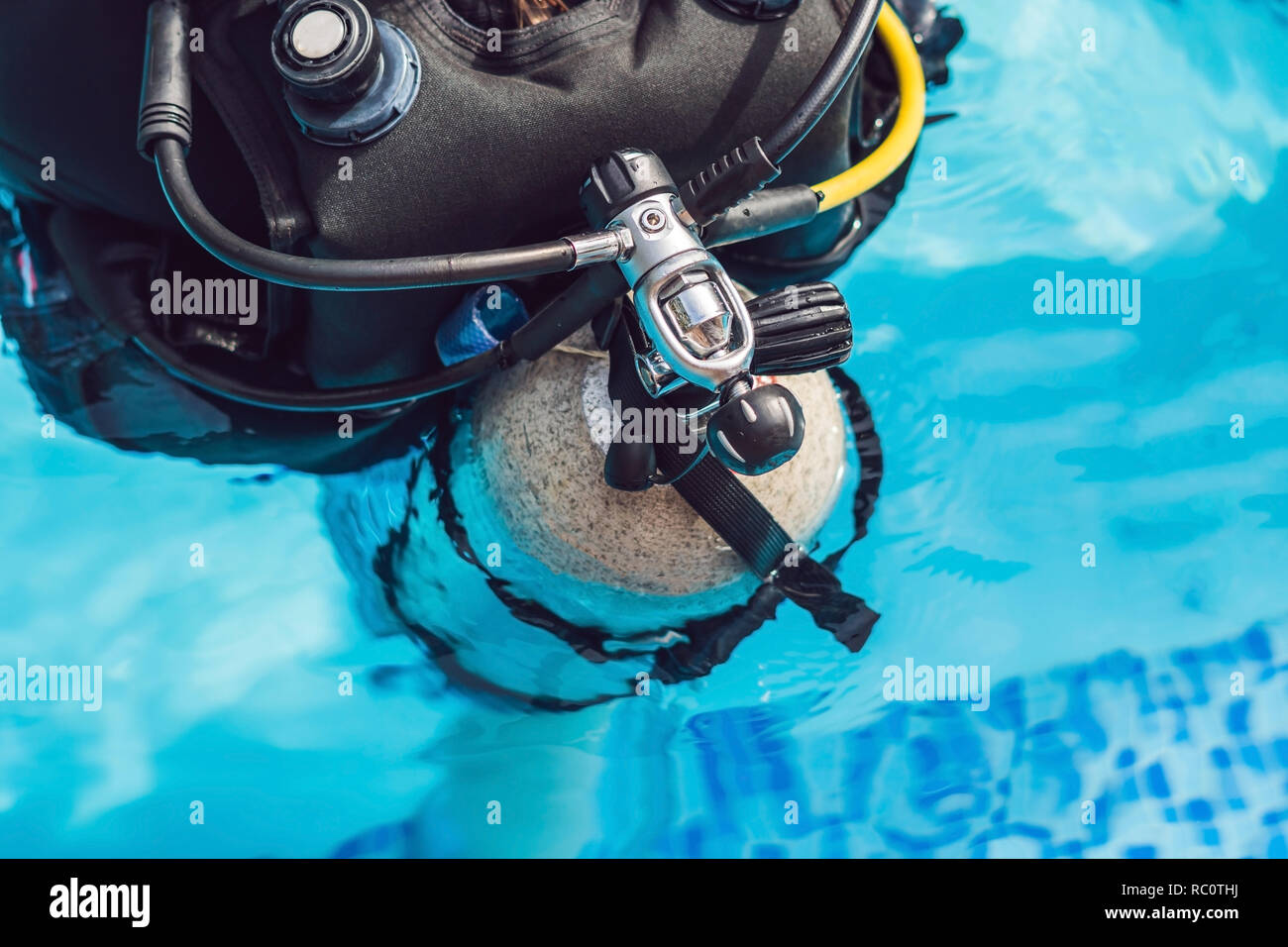 grey scuba diving air oxygen tank on the back of a scuba diver Stock