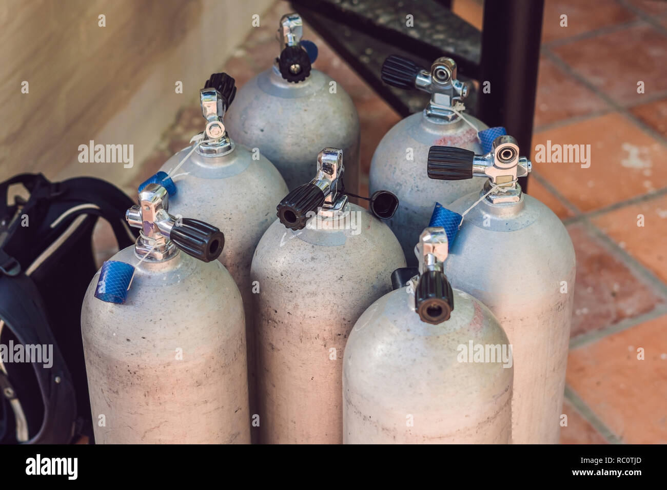 Collection of grey scuba diving air oxygen tanks waiting Stock Photo