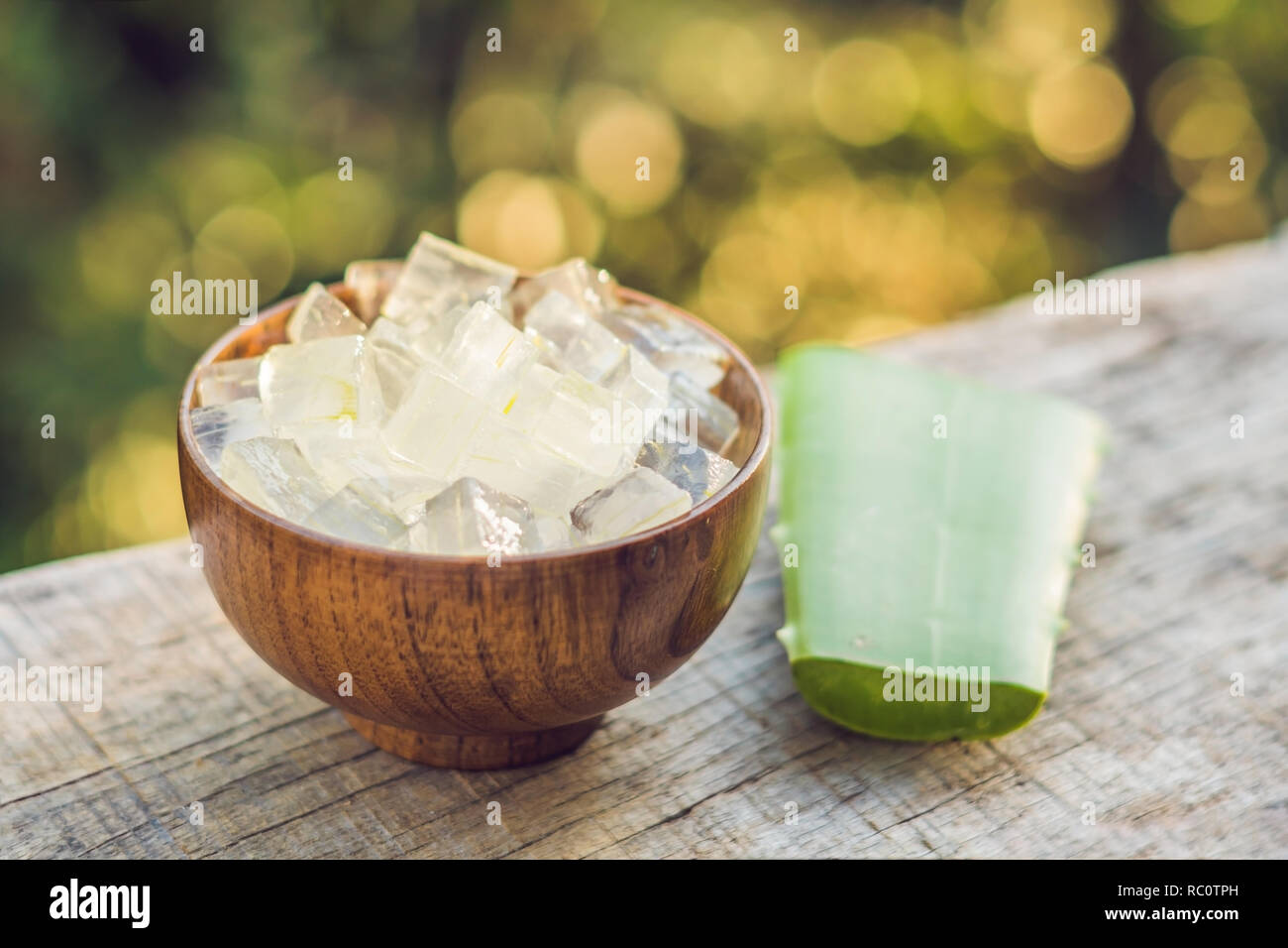 Aloe vera and aloe cubes in a wooden bowl. Aloe Vera gel almost use in food, medicine and beauty industry. Stock Photo
