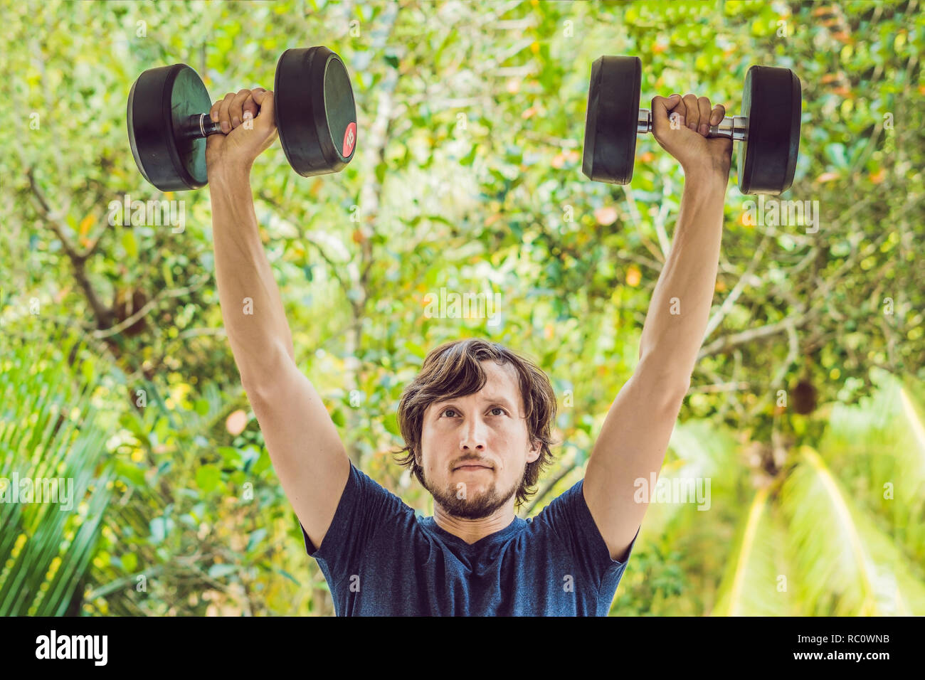 Bicep curl weight training fitness man outside working out arms
