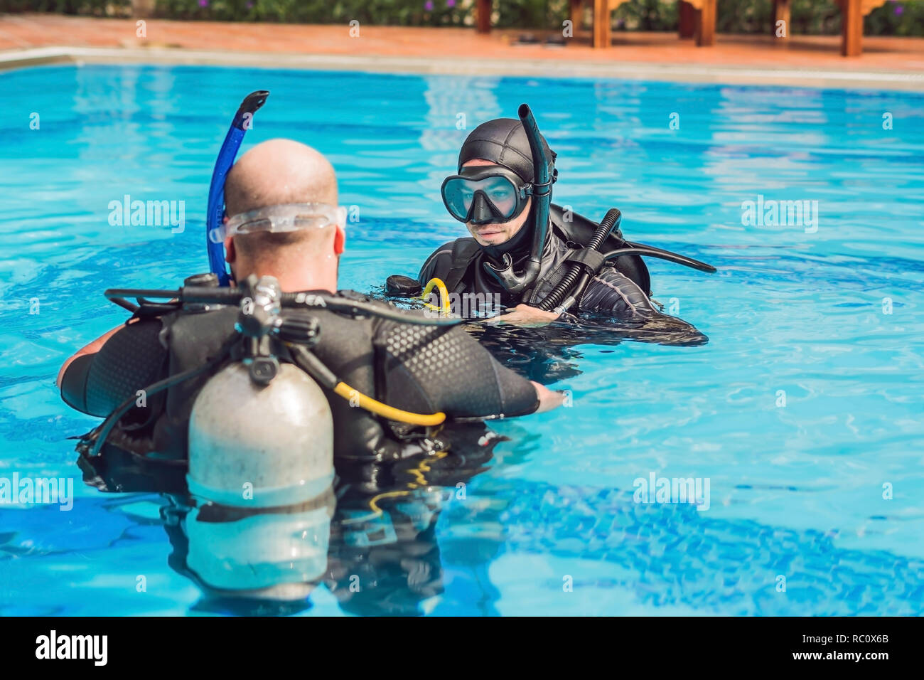Diving instructor and students. Instructor teaches students to dive