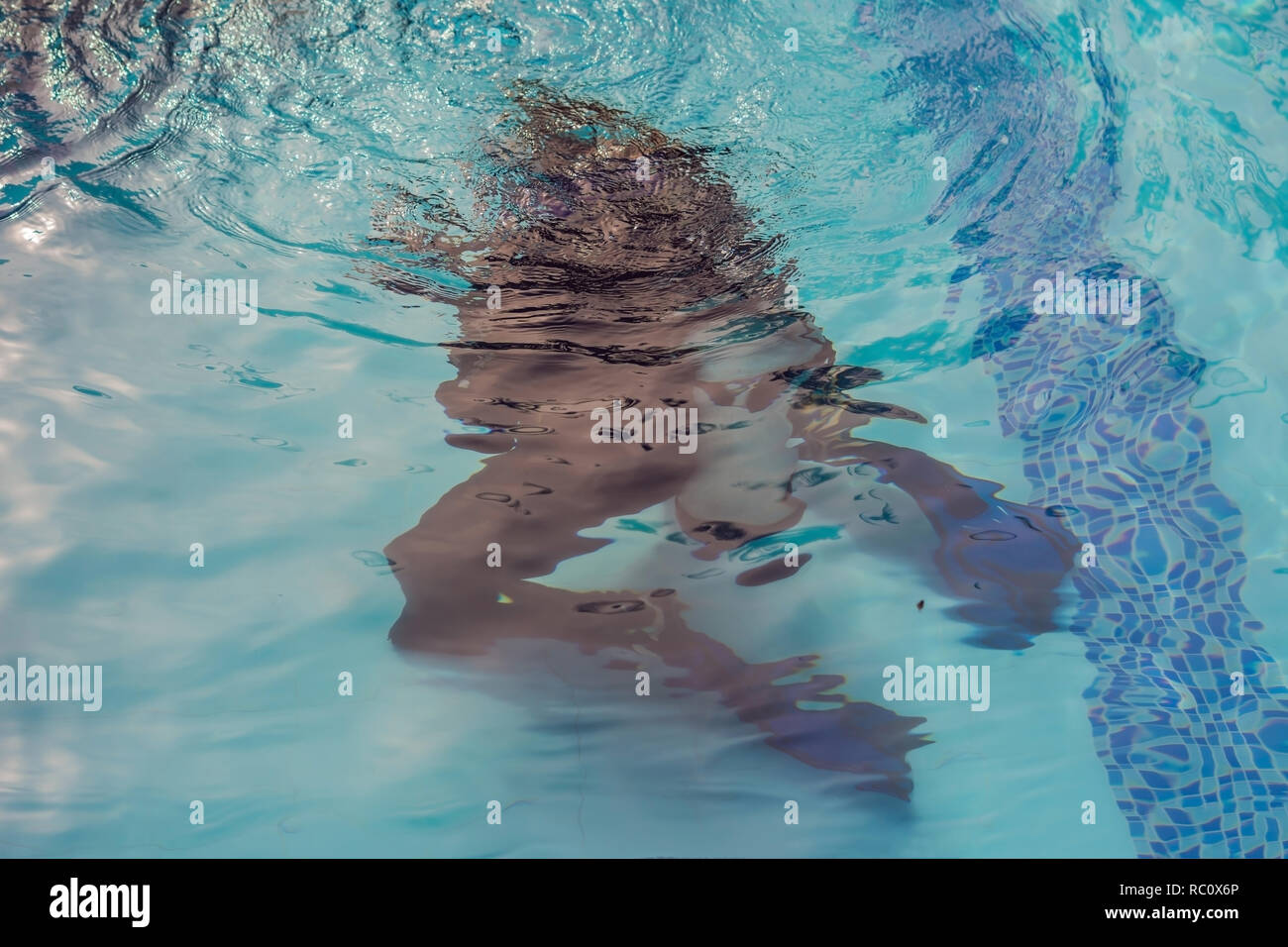 Diving instructor and students. Instructor teaches students to dive