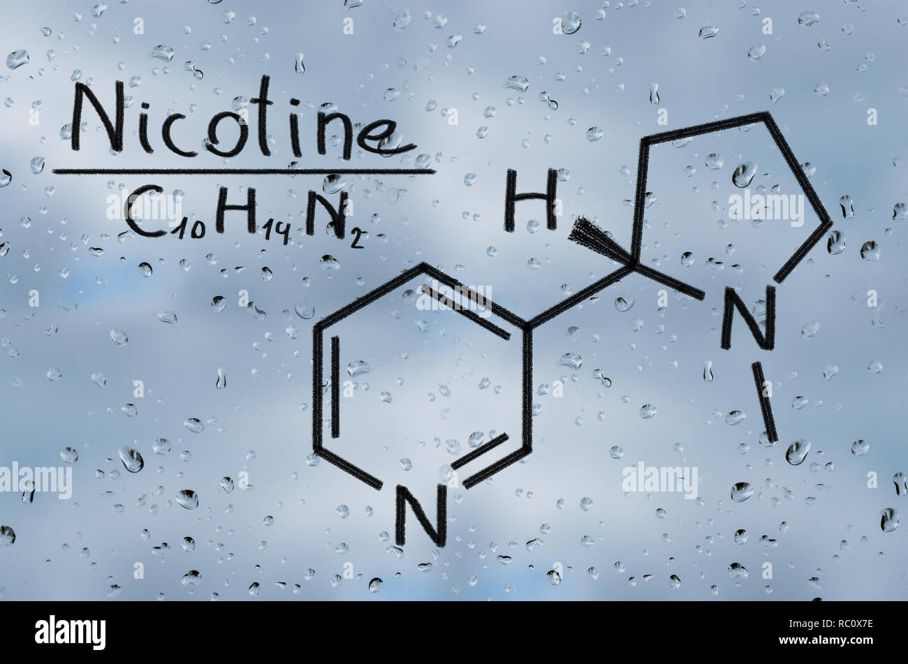 Structural model of Nicotine on the glass with raindrops. Stock Photo