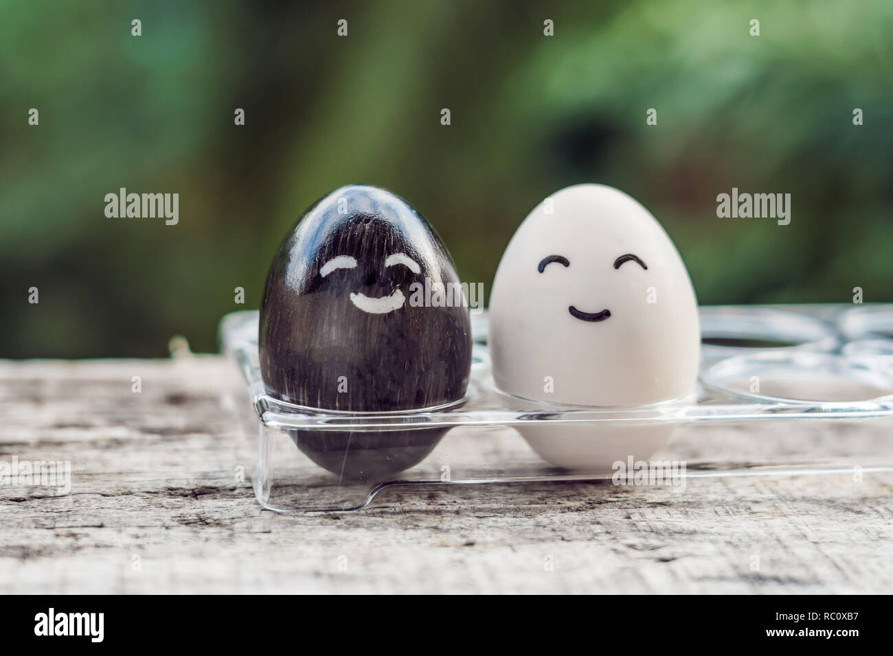 interracial marriage concept. Black and white egg as a pair of different races. Stock Photo