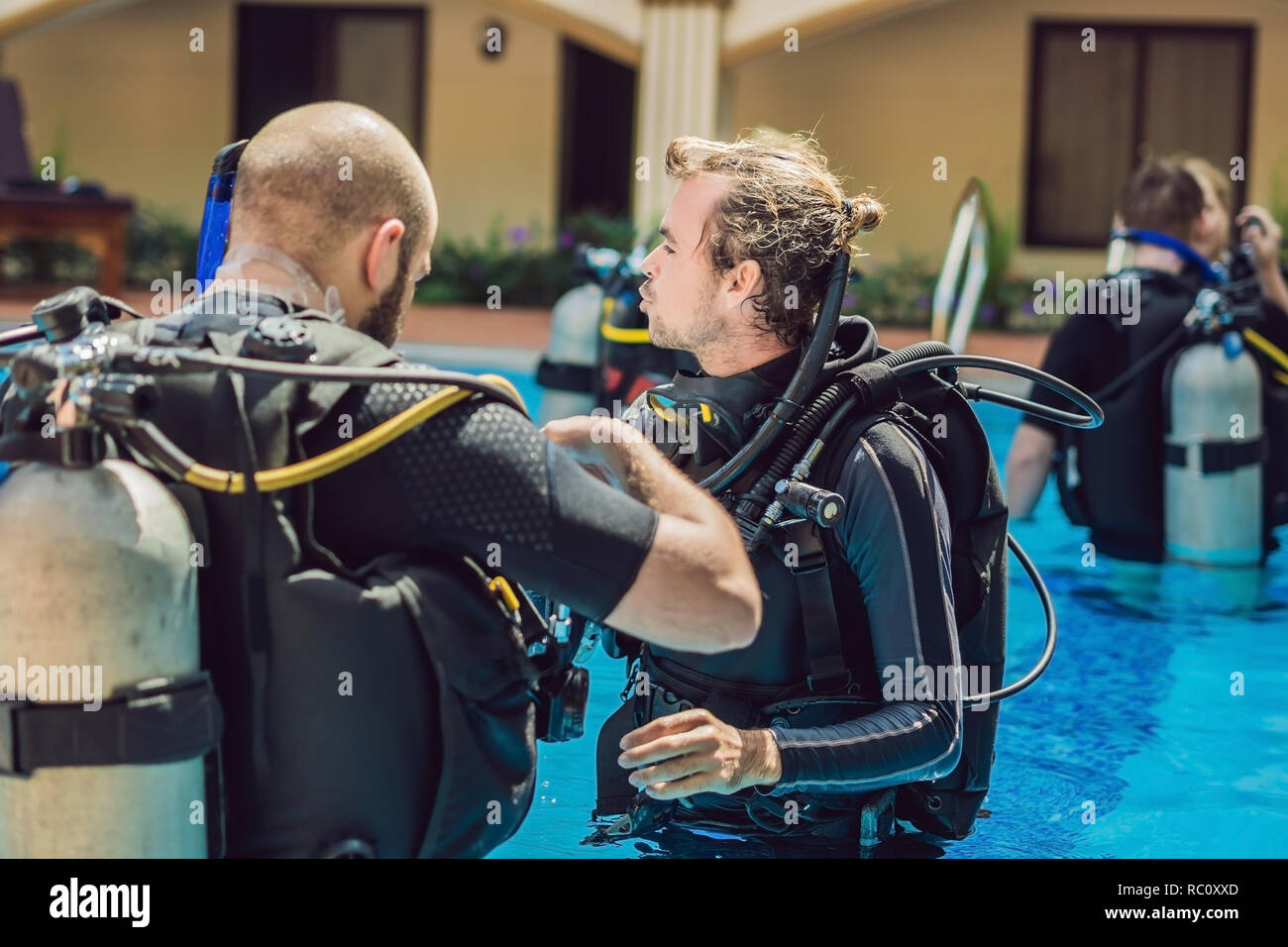 Diving instructor and students. Instructor teaches students to dive