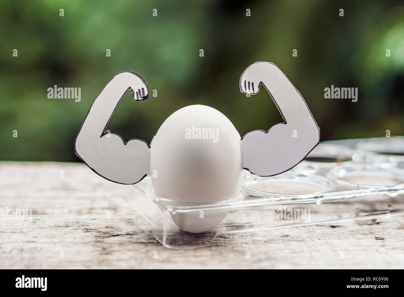 Egg with muscles, concept of egg protein, sports nutrition, diet for