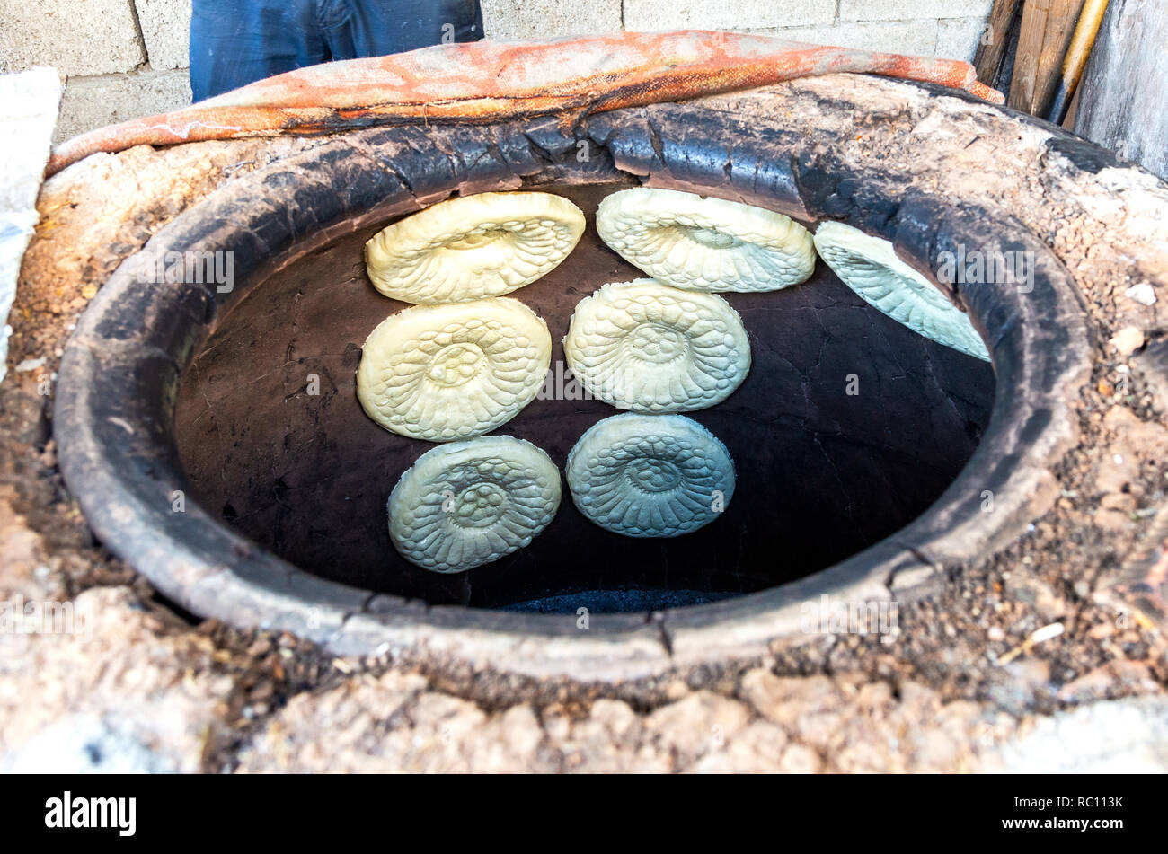 Traditional Uzbek flatbread baking in the tandir oven Stock Photo Alamy