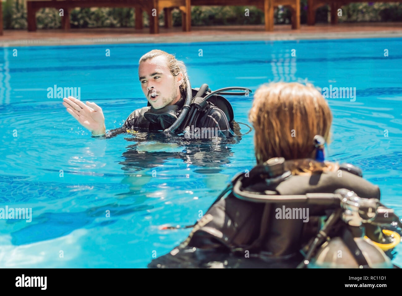 Diving instructor and students. Instructor teaches students to dive