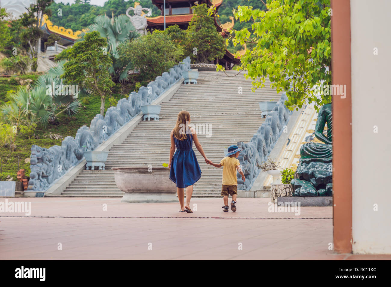 Happy tourists mom and son in Pagoda. Travel to Asia concept. Traveling with a baby concept. Stock Photo