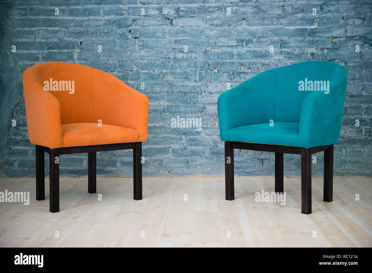Two chairs against a gray brick wall. Interior. Stock Photo