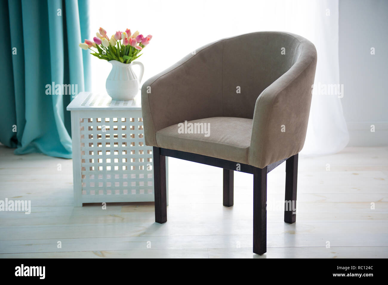 Beige chair on the background of the window. The interior of the ...