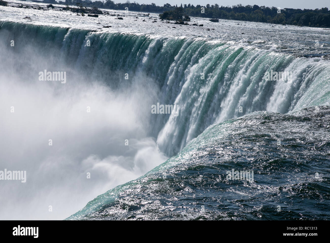 Close up view on Niagara Fall waters on the edge of the waterfall. Bright summer day. Stock Photo