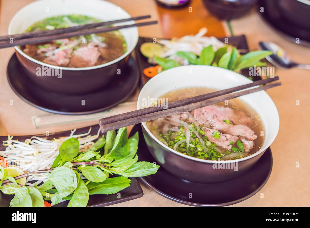 Pho Bo Vietnamese fresh rice noodle soup with beef, herbs and chili