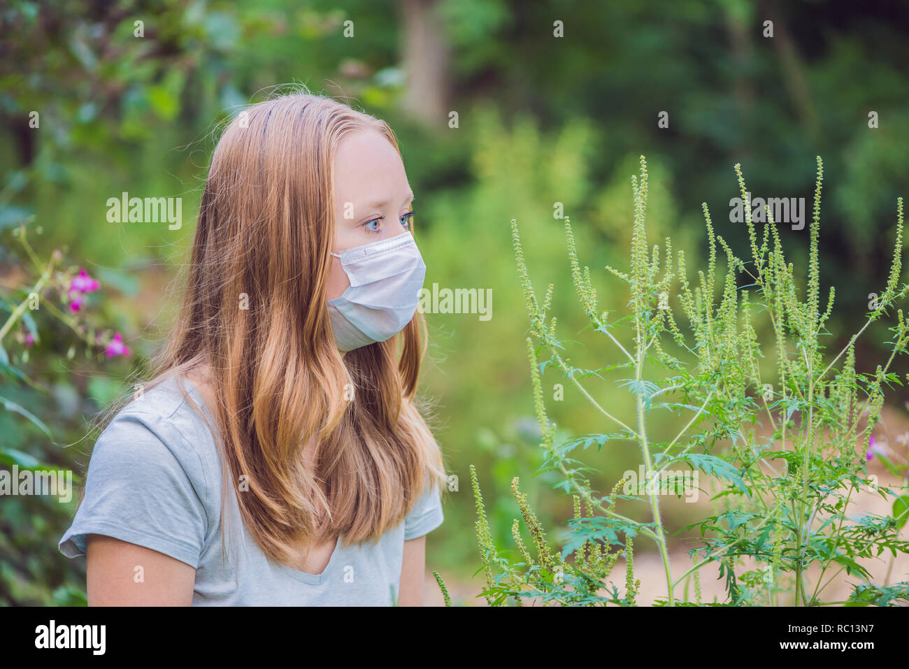 Young woman in a medical mask because of an allergy to ragweed Stock Photo