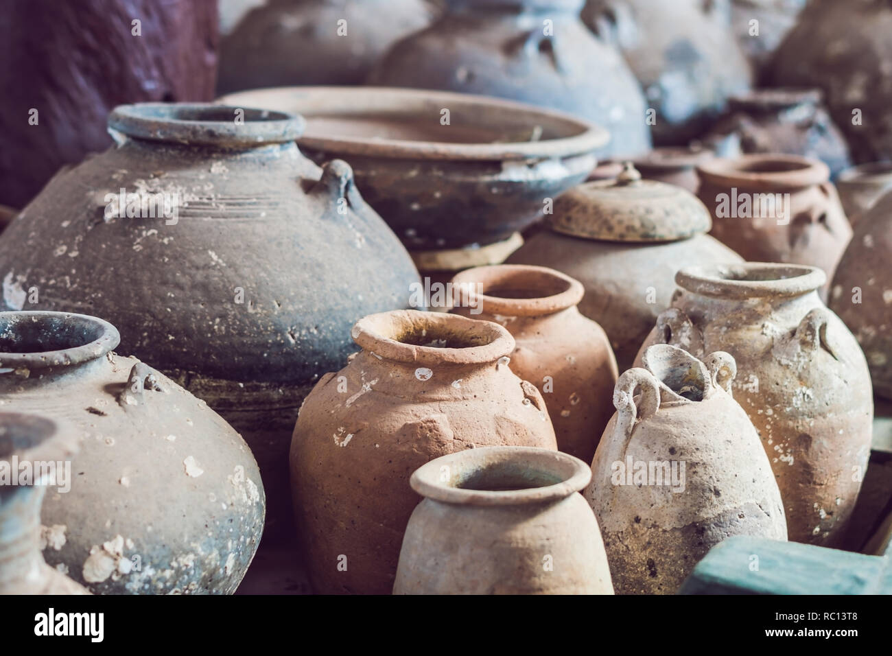 Ancient Vietnamese traditional pots overgrown with seashells Stock Photo