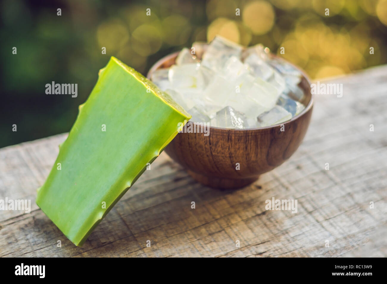 Aloe vera and aloe cubes in a wooden bowl. Aloe Vera gel almost use in food, medicine and beauty industry Stock Photo