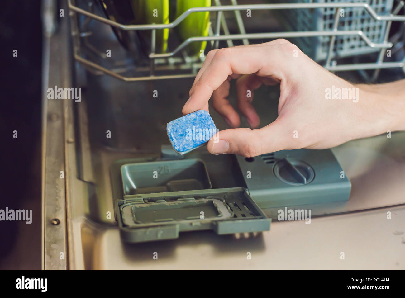 Dishwasher with dirty dishes. Powder, dishwashing tablet and rinse aid