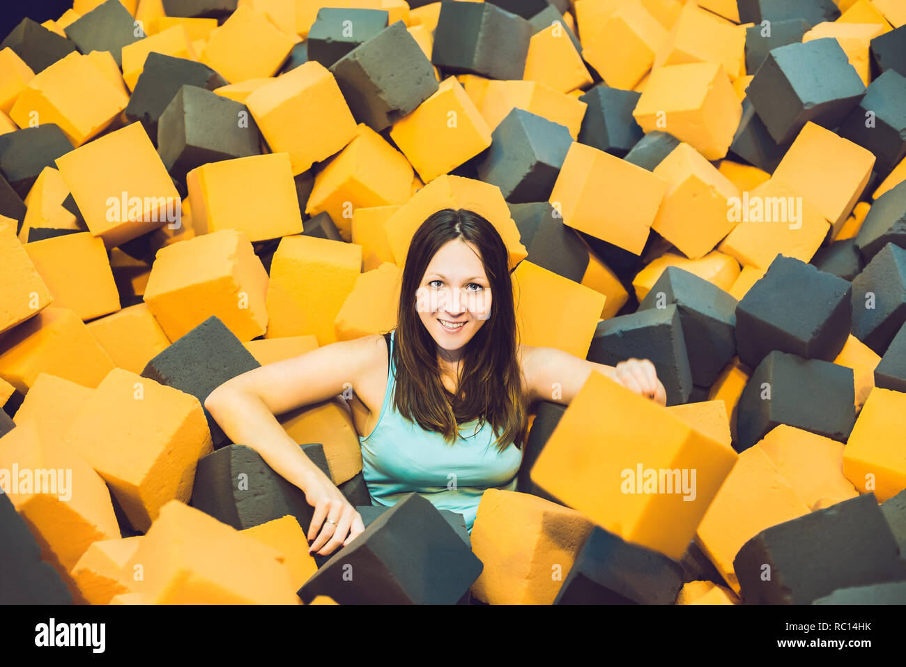 Young woman playing with soft blocks at indoor children playground