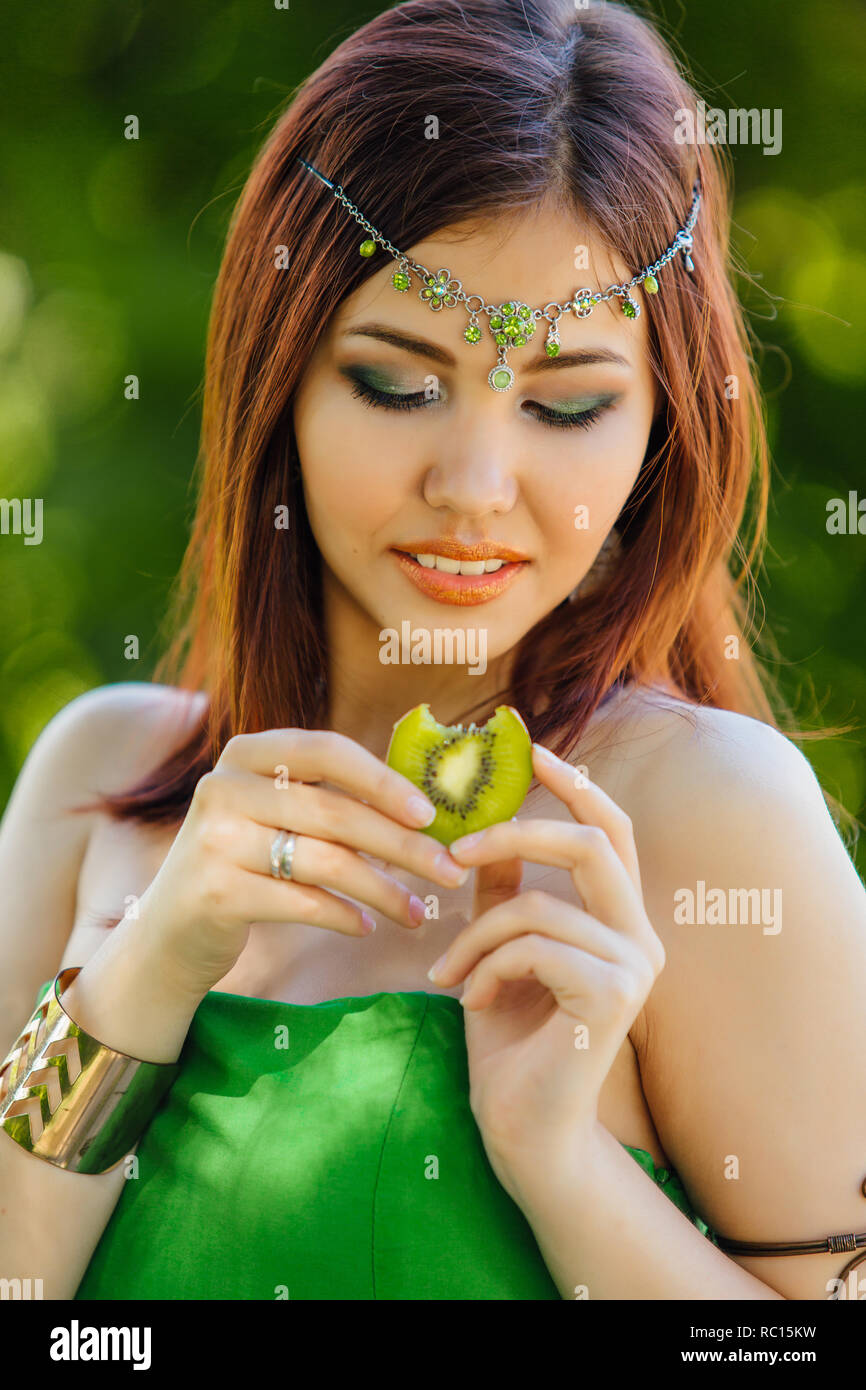 Portrait of a beautiful young asian woman in green dress and diadema on ...