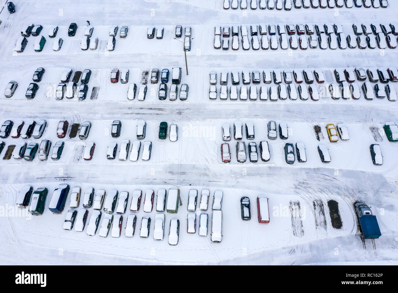 urban parking lot with parked cars in the parking lot on a winter day ...