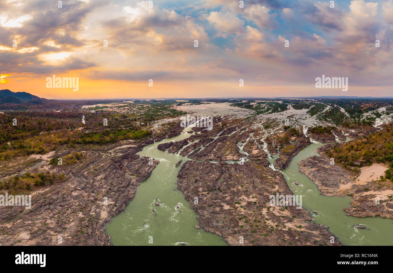 Aerial panoramic 4000 islands Mekong River in Laos, sunset dramatic sky, Li Phi waterfalls, famous travel destination backpacker in South East Asia Stock Photo