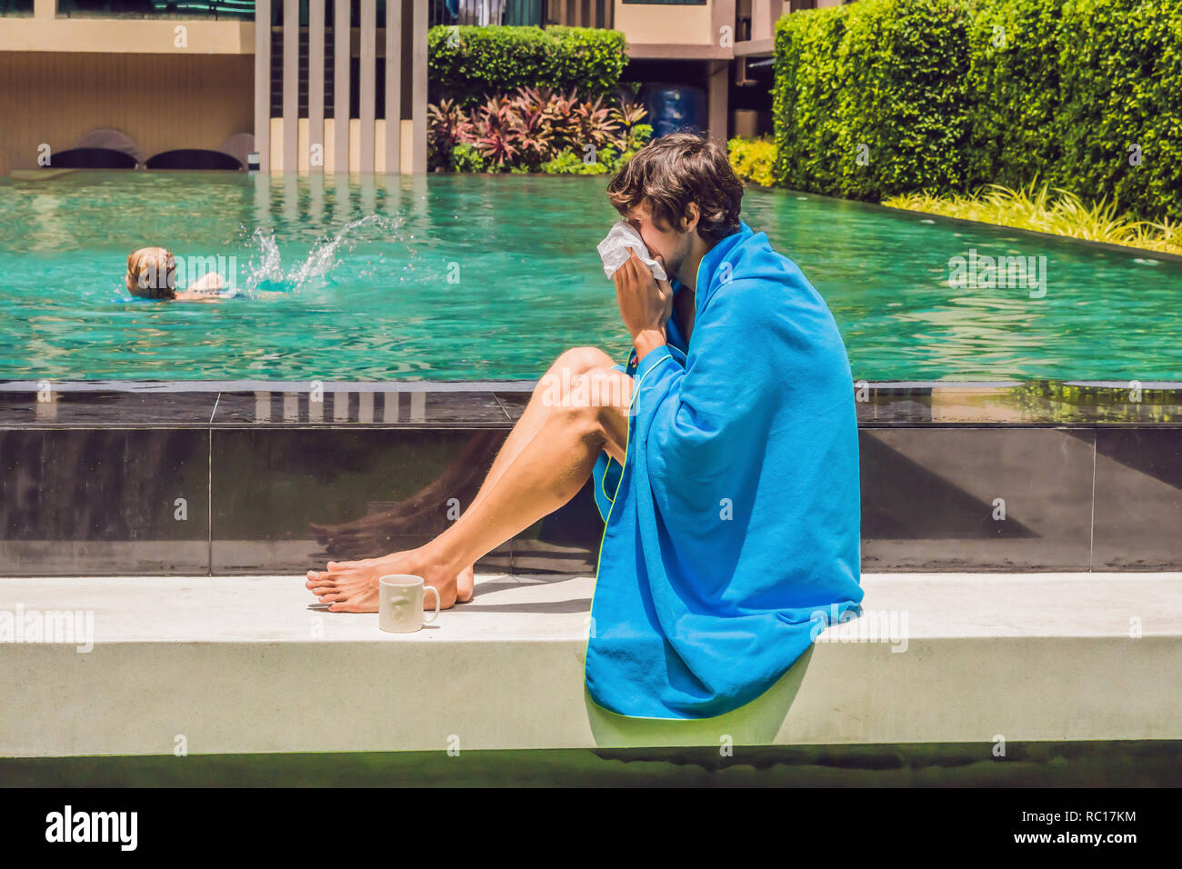 Sick man traveler. The man caught a cold on vacation, sits sad at the