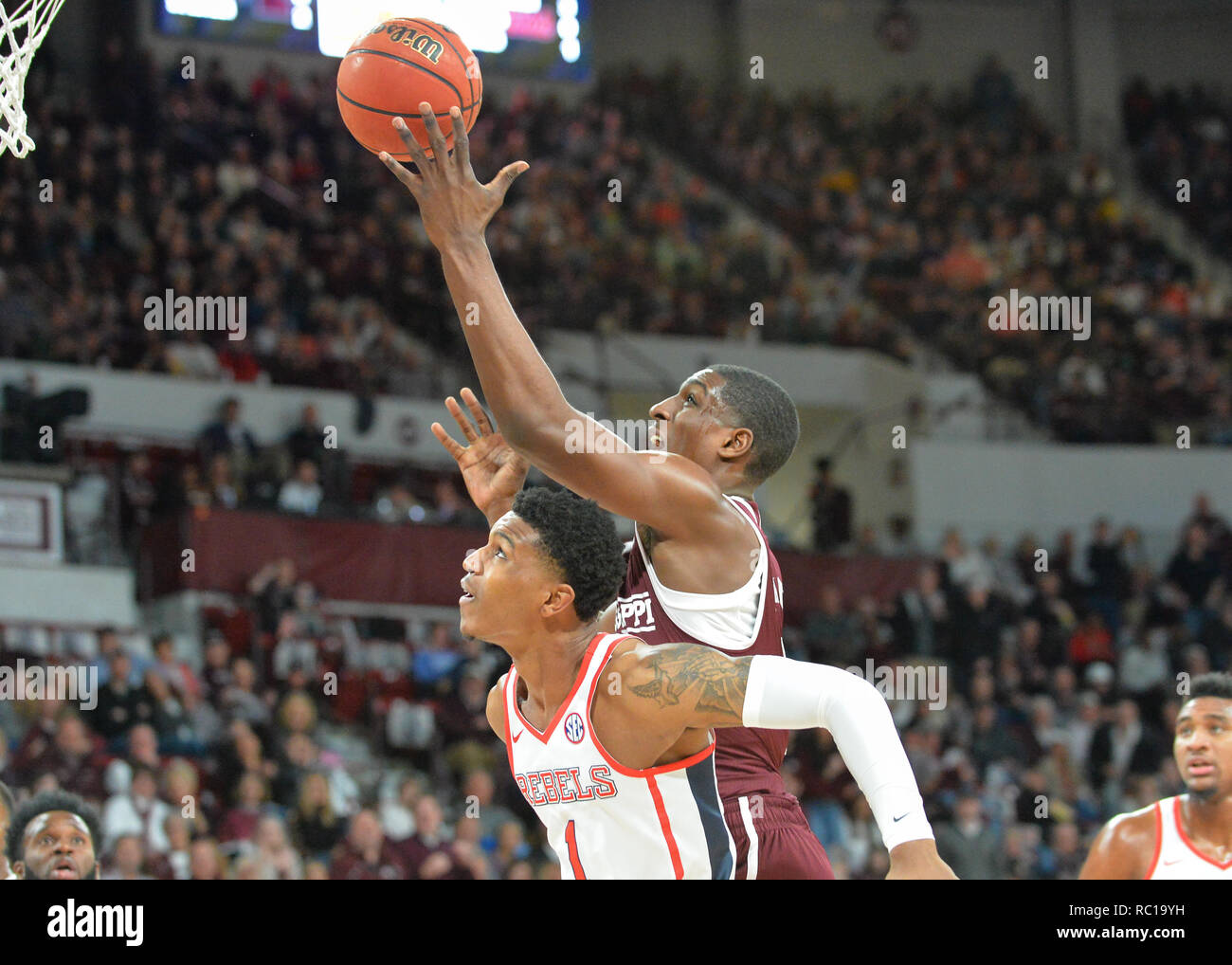 Starkville, MS, USA. 12th Jan, 2019. Mississippi State forward, Reggie  Perry (1), drives to the basket over the back of Ole' Miss forward, Zach  Naylor (1), during the NCAA basketball game between