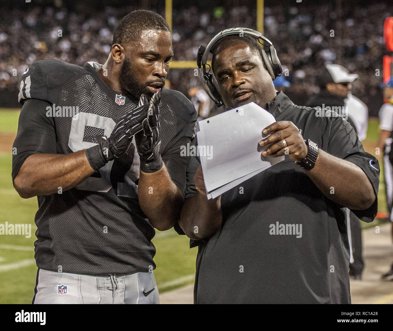 Oakland, California, USA. 15th Aug, 2014. August 15, 2014 Oakland Raiders defensive end Justin Tuck (91) works with defensive line coach Terrell Williams on Friday, August 15, 2014, at O.co Coliseum in Oakland, California. The Raiders defeated the Lions 27-26 in a preseason game. Credit: Al Golub/ZUMA Wire/Alamy Live News Stock Photo