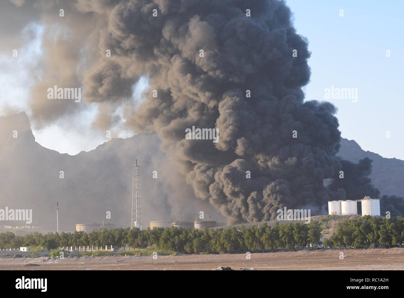 Aden, Yemen. 12th Jan, 2019. Photo taken on Jan. 12, 2019 shows heavy smoke from a state-owned oil refinery in Aden, Yemen. A new powerful explosion hit the the state-owned oil refinery in Aden on Saturday evening, injuring at least 15 people, a security official told Xinhua. Credit: Murad Abdo/Xinhua/Alamy Live News Credit: Xinhua/Alamy Live News Stock Photo