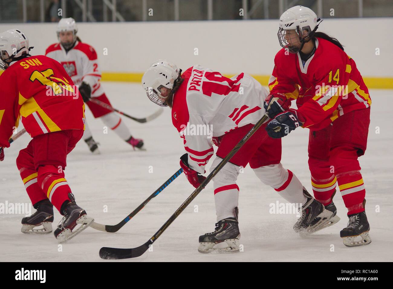 Dumfries, Scotland, 12 January 2019. Yuting Sun of China being followed by Vanessa Patla of Poland and Qianhua Li during their match in the 2019 Ice Hockey U18 Women’s World Championship, Division 1, Group B, at Dumfries Ice Bowl. Credit: Colin Edwards/Alamy Live News. Stock Photo