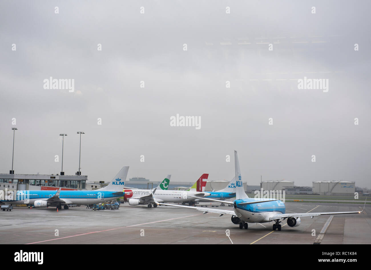 KLM Royal Dutch Airlines planes are seen at Amsterdam Schiphol Airport runway. Stock Photo