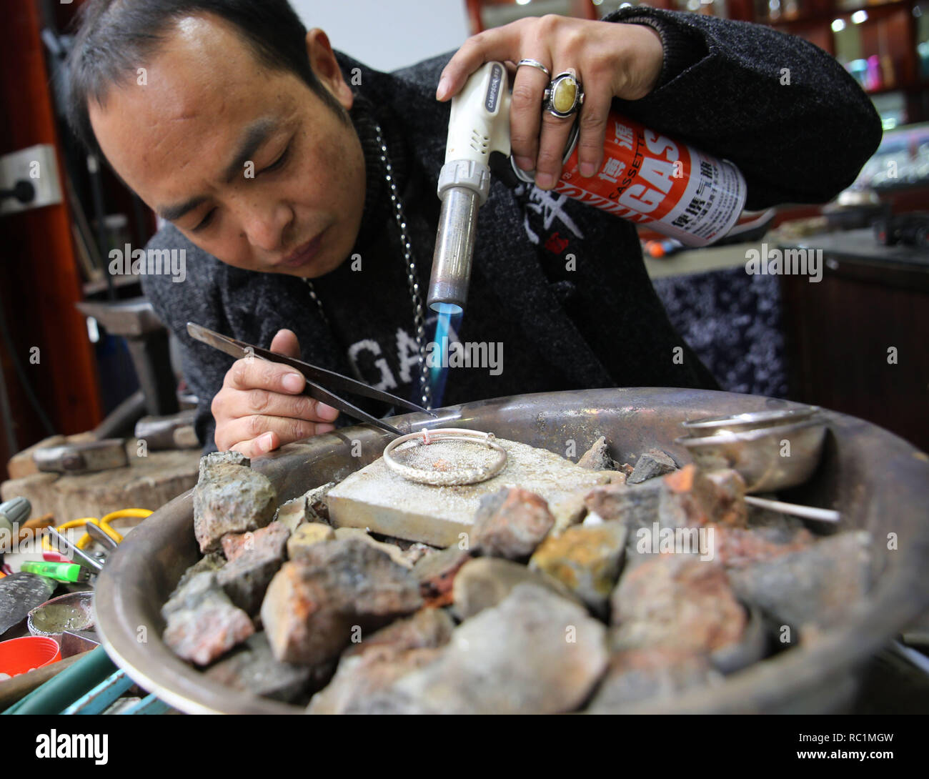 Zhangjiajie, China's Hunan Province. 13th Jan, 2019. Craftsman Tian Yinzhong makes silverware at a workshop in Wulingyuan District of Zhangjiajie, central China's Hunan Province, Jan. 13, 2019. As the Spring Festival is approaching, more traditional silverwares are in demand. The local workshops have been expanding production and promoting sales through live streaming and online platforms. Credit: Wu Yongbing/Xinhua/Alamy Live News Stock Photo