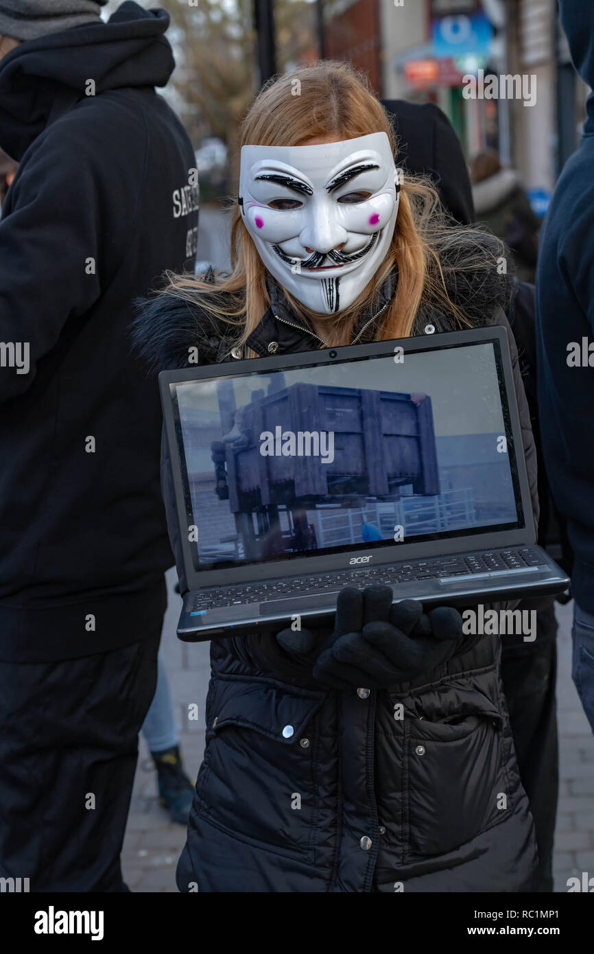 Brentwood, Essex, UK.  13th January 2019.  A cube of truth protest in Brentwood High Street by Anonymous for the voiceless; a group promoting Veganism and animal welfare.  The laptops and video screens show distressing footage of alleged animal cruelty. Anonymous for the Voiceless is a street activist organization dedicated to total animal liberation. They expose to the public the animal exploitation that is intentionally hidden from them. Combining this with a value-based sales approach and resource literature, They fully equip the public with everything they need to switch to a vegan lifesty Stock Photo