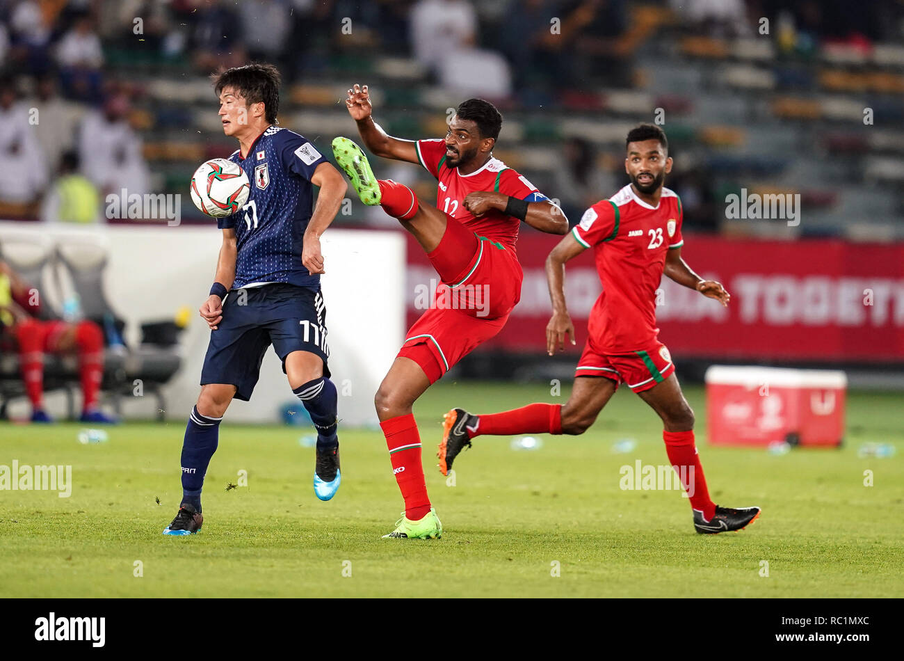 Abu Dhabi, UAE. 13th January 2019. Zayed Sports City Stadium, Abu Dhabi,  United Arab Emirates; AFC Asian Cup football, Oman versus Japan; Ahmed Kano  of Oman with a high boot foul on