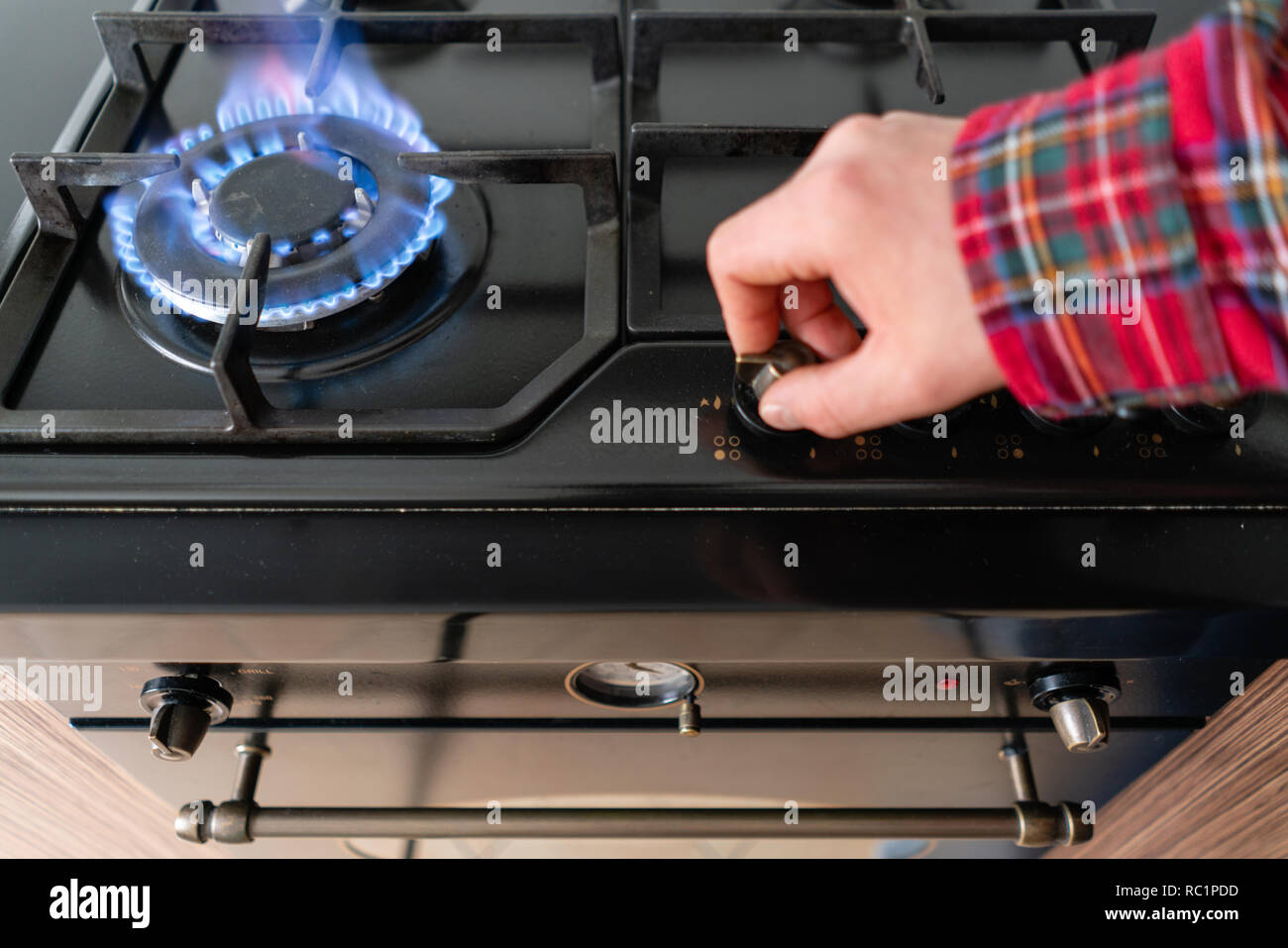 Closeup shot of blue fire from domestic kitchen hob. Gas cooker with