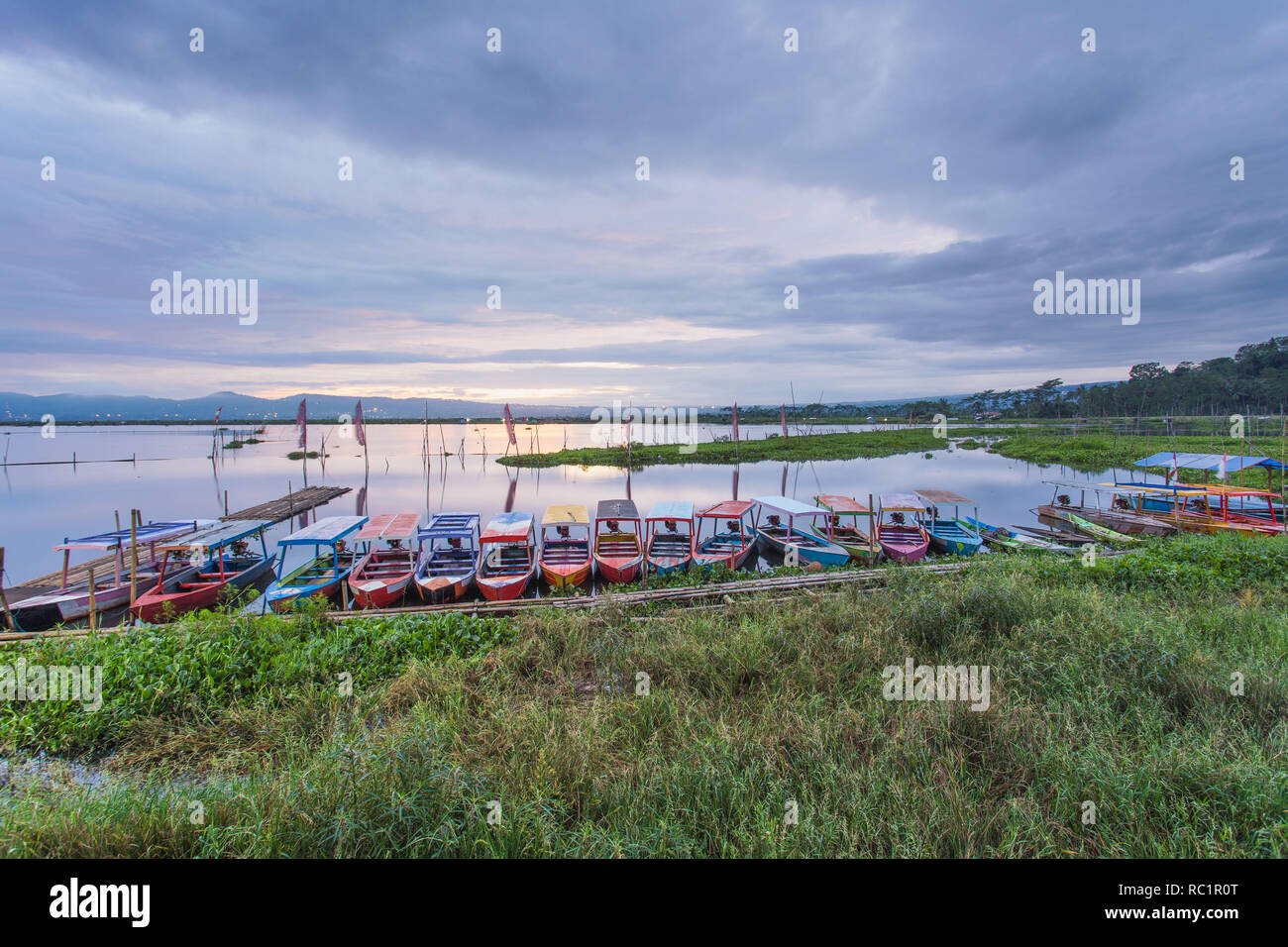 Colorful tourist boats parked at side of Rawa Pening Lake, Central Java, Indonesia Stock Photo
